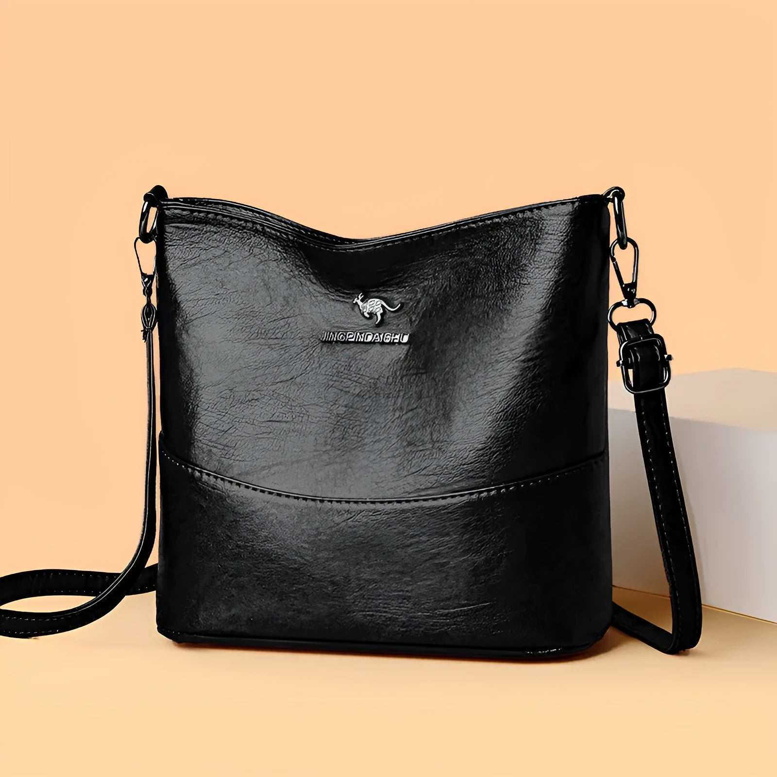 Women's casual soft leather bucket shoulder bag in black, wine red, or ginger yellow, showing large capacity and minimalist design.