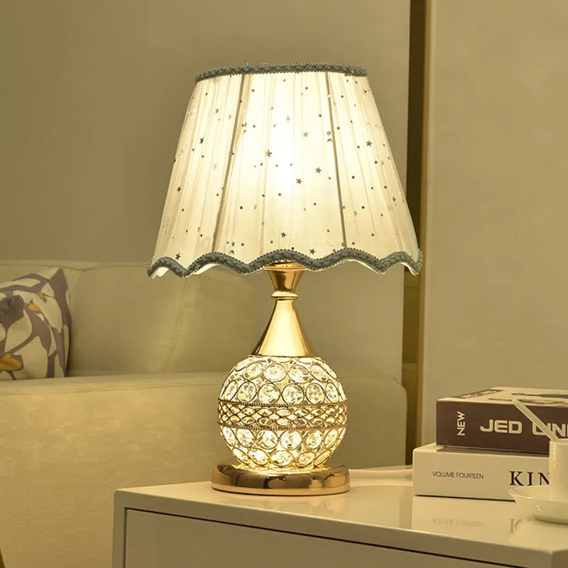 Gold crystal desk lamp with iron art base and remote control on wooden table