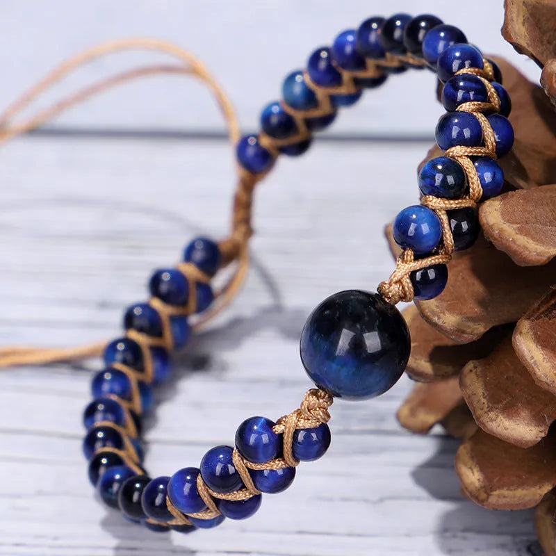 Hand-woven geometric pull bracelet made from blue Tigereye stone beads with an adjustable slip knot.