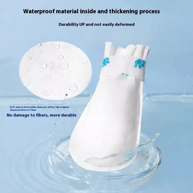 Pack of white disposable waterproof shoe covers for dogs on a non-slip sole.