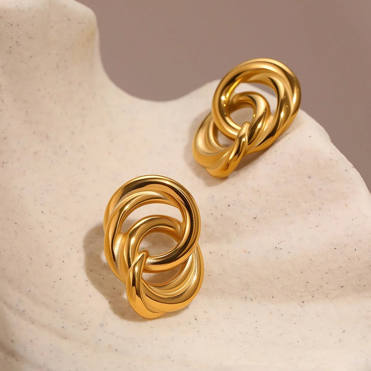 Gold geometric stud earrings with 18K electroplated finish on stainless steel