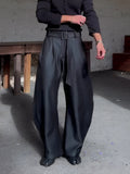 Chic black oversized wide-leg pants with high-waisted belt