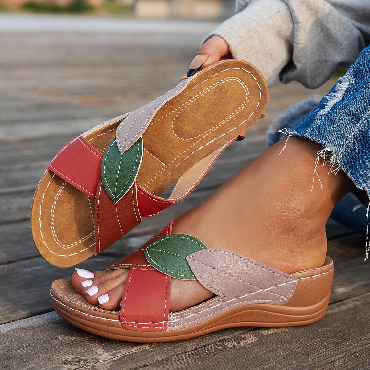 Women's black thick-soled slippers with cross-straps and a peep-toe opening on a white background.