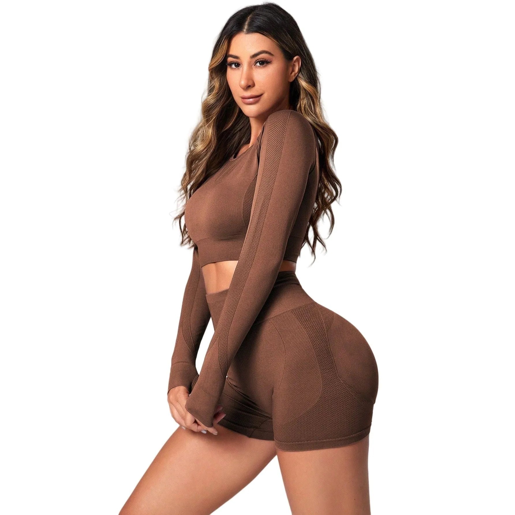 Women's black yoga set comprising a long sleeve top and high-waist trousers laid flat.