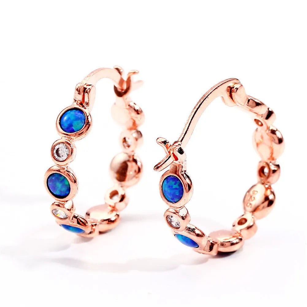 Round copper earrings with synthetic opal and cubic zirconia in platinum white finish