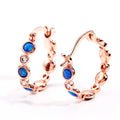 Round copper earrings with synthetic opal and cubic zirconia in platinum white finish