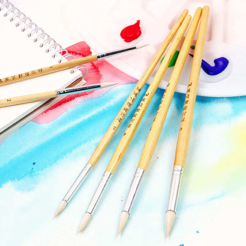 Set of six wooden hook line pen brushes for yarn craft on a table.