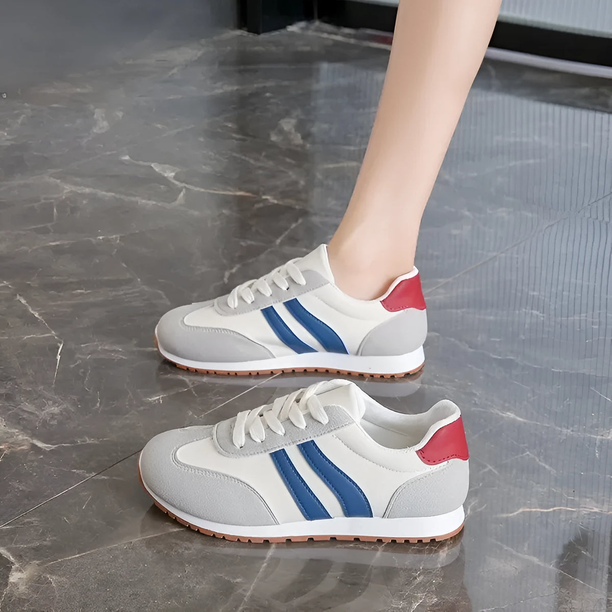 Blue and grey striped Cortez-style leisure sports shoes with a flat rubber sole.