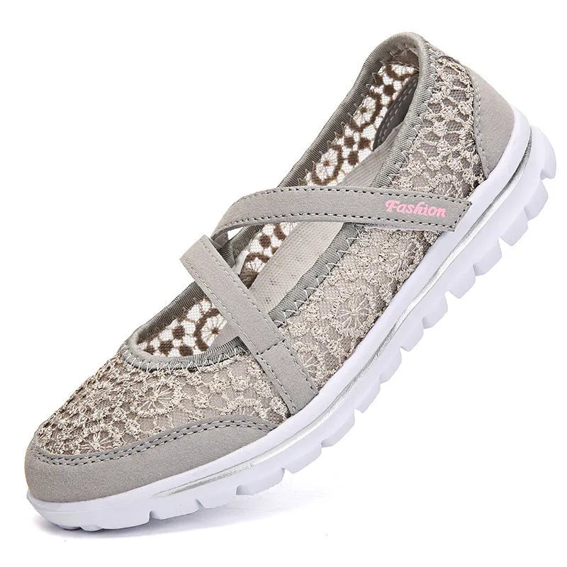 Women's flat lace-up casual shoes with mesh upper in beige, shown from the side.