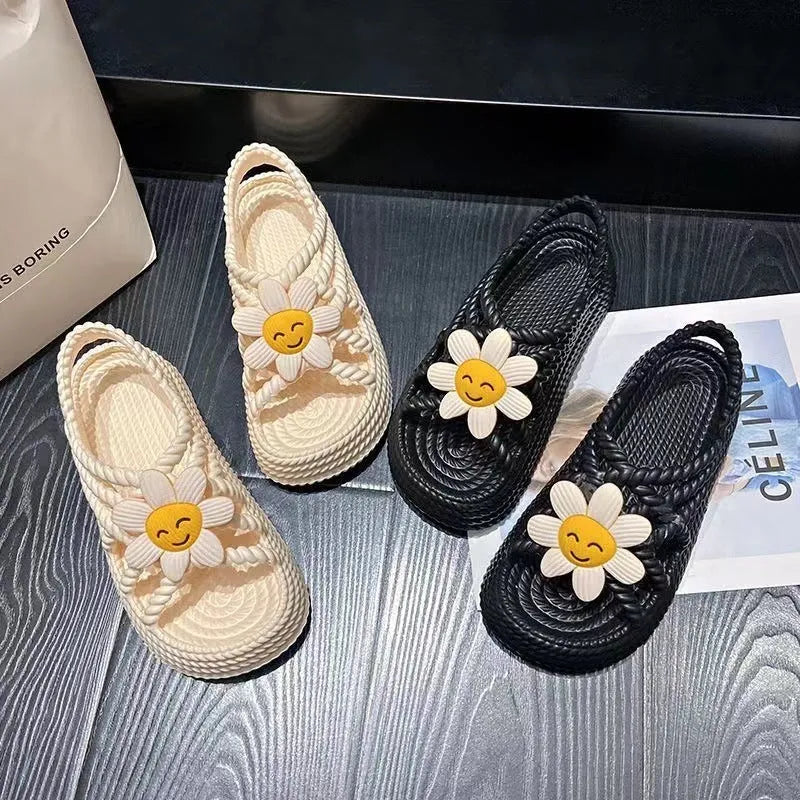 Beige PVC sandals with a round toe, non-slip sole, and a sunflower decoration.