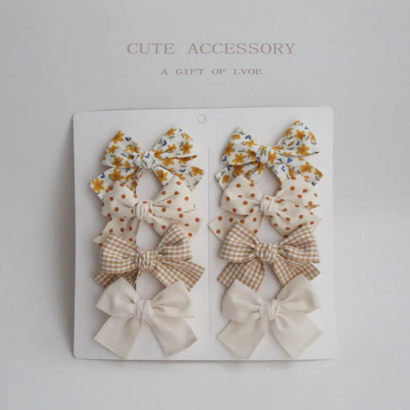 Children's cloth bow hairclip set showing dovetail shape in multiple colour options