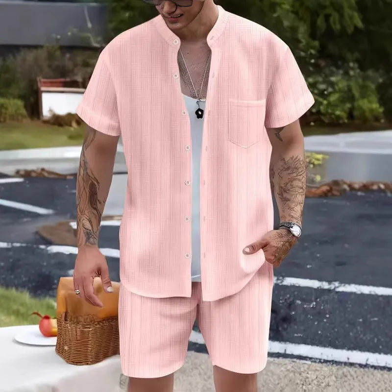 Men's Henry collar short sleeve shirt and shorts set in apricot placed on flat surface
