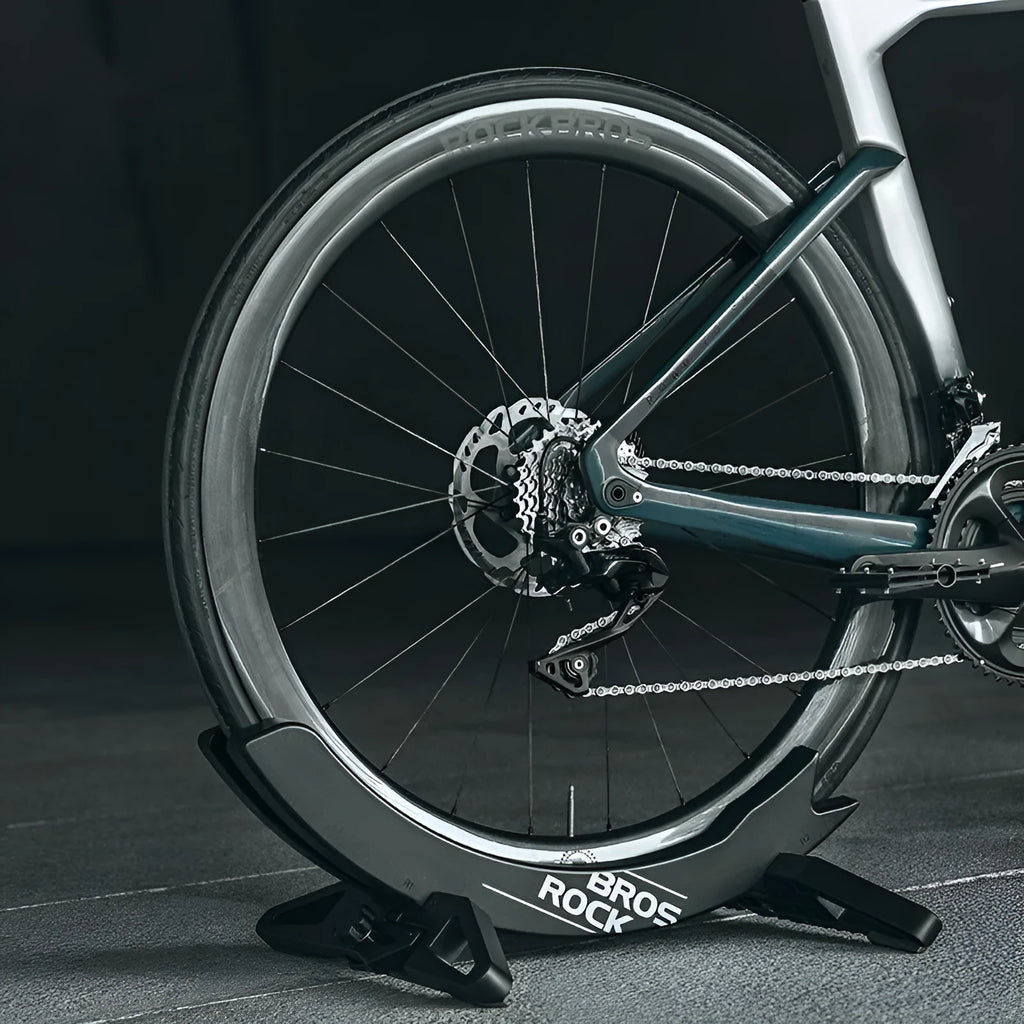 Black ABS plastic wall-mounted bicycle parking rack holder holding a mountain bike.