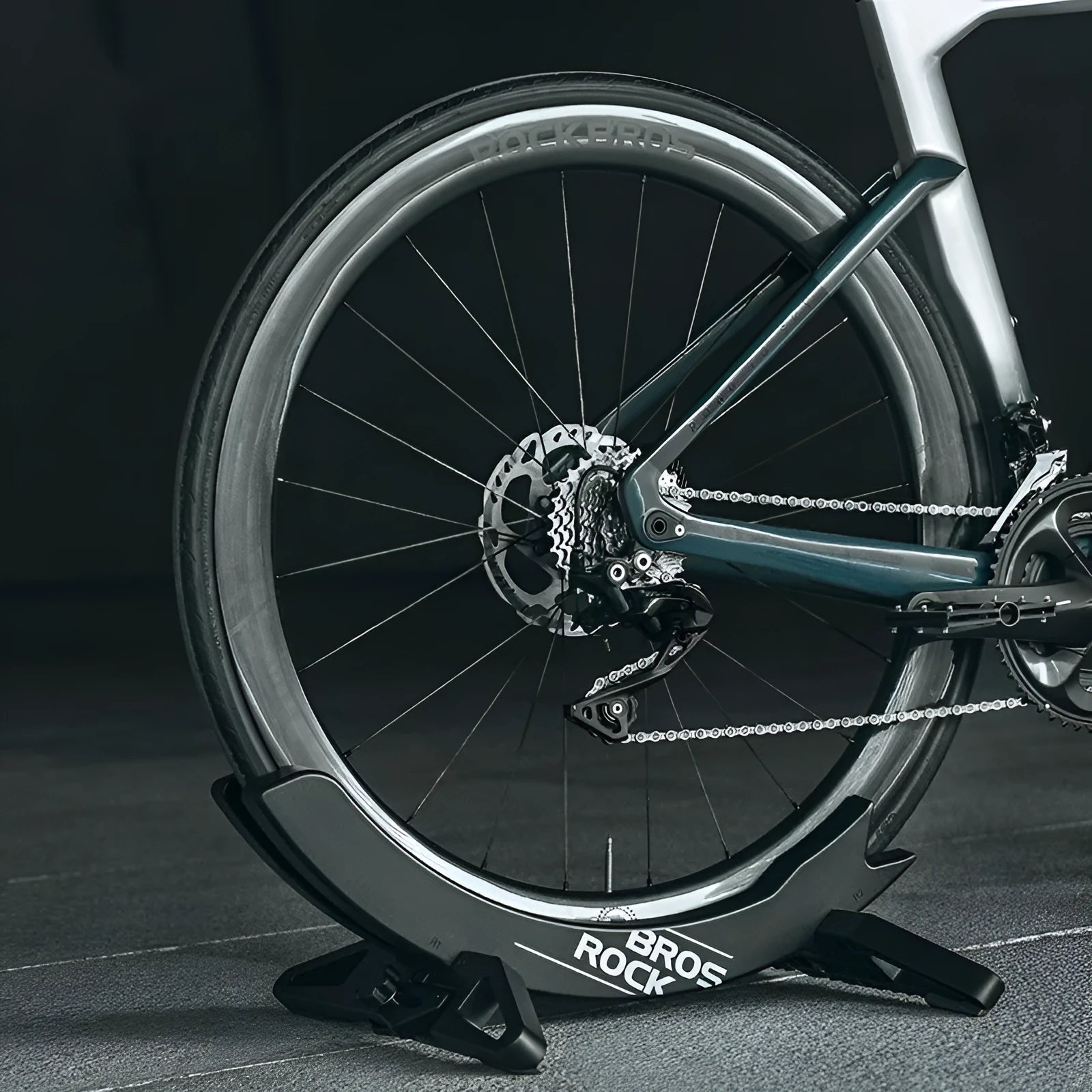 Black ABS plastic wall-mounted bicycle parking rack holder holding a mountain bike.