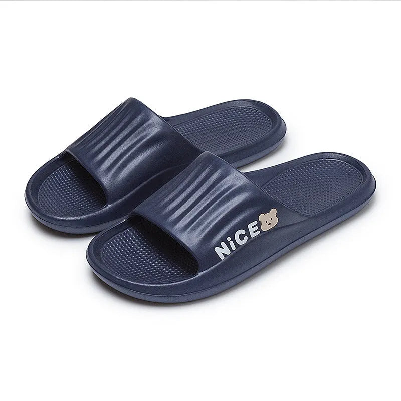 Pair of lightweight EVA flip-flop slippers with a minimalist cartoon pattern and non-slip soles.