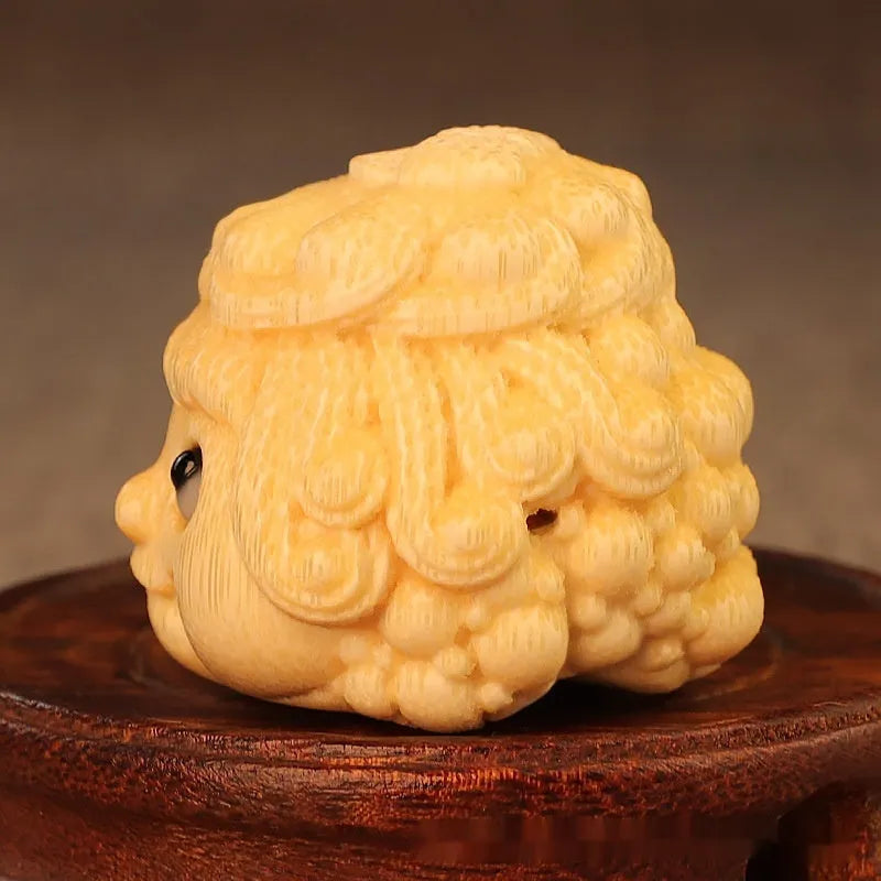 Solid bamboo carving of a cute Golden Toad Princess ornament on a neutral background.