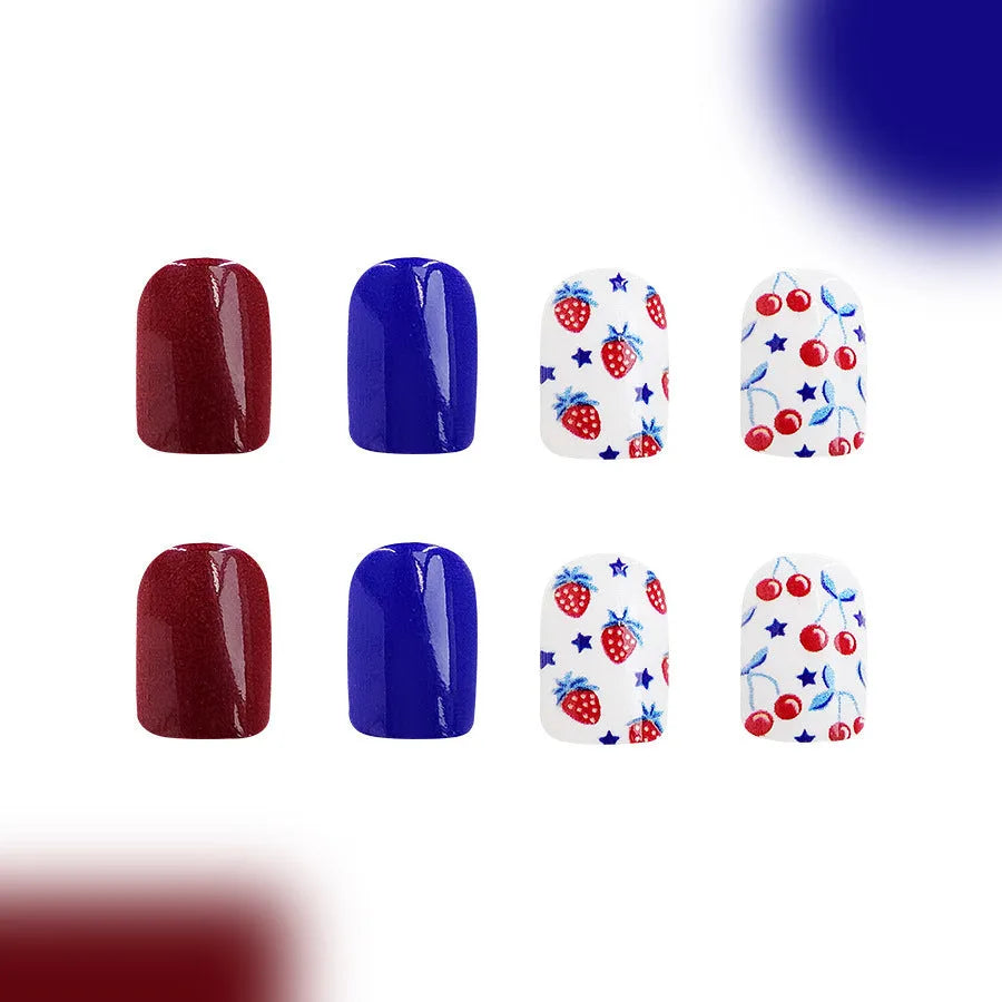 Short glossy false nails with strawberry cherry independence day pattern in red and blue colours