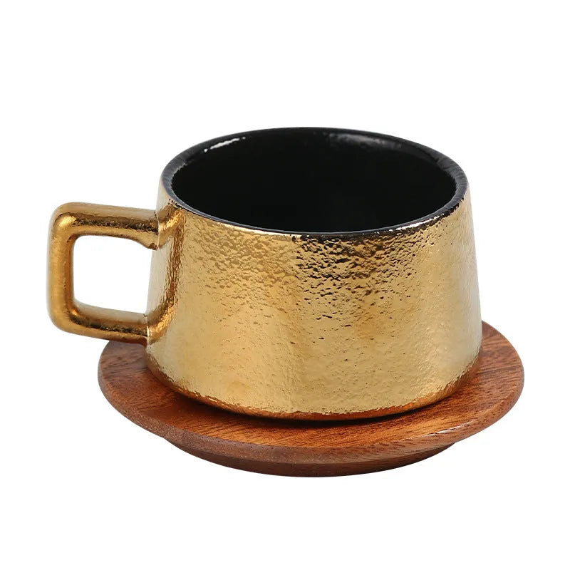 Gold-plated gift tumbler cup and box set on a desk
