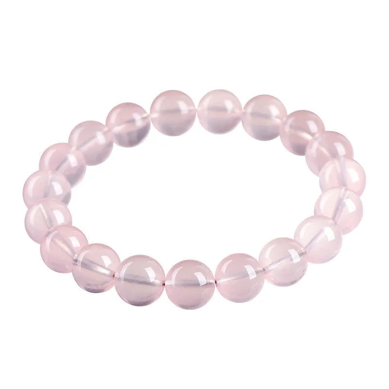 Polished natural crystal bracelet with round pink beads in starlight style, showing colour and size options.
