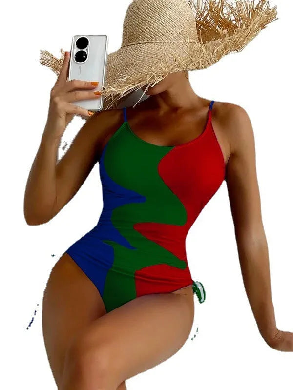 Women's blue sleeveless backless one-piece swimsuit on a hanger showing striped print detail.