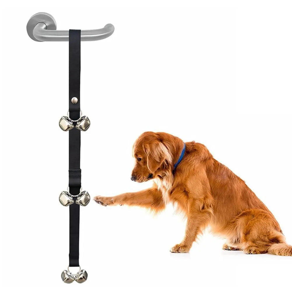 Adjustable dog training doorbell with silver metal bells on a black nylon leash, hung on a door.