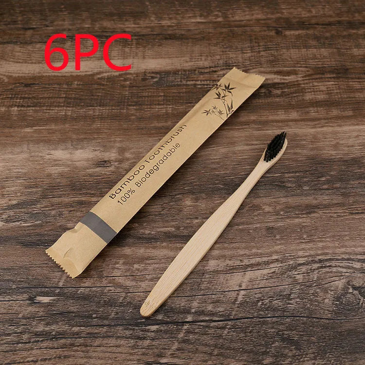 10 bamboo toothbrushes with coloured handles and charcoal bristles displayed together