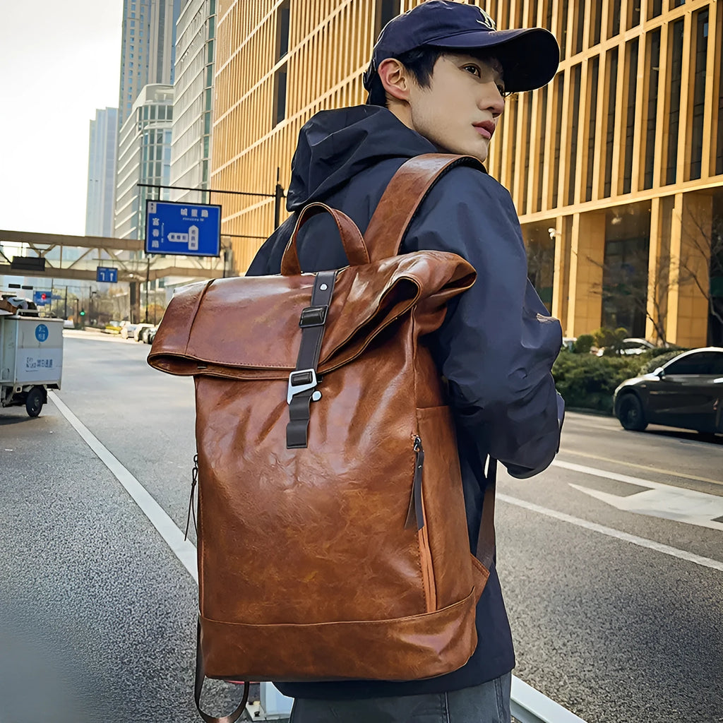 Large capacity PU leather backpack in black, solid colour, with curved shoulder straps and visible sewing line details