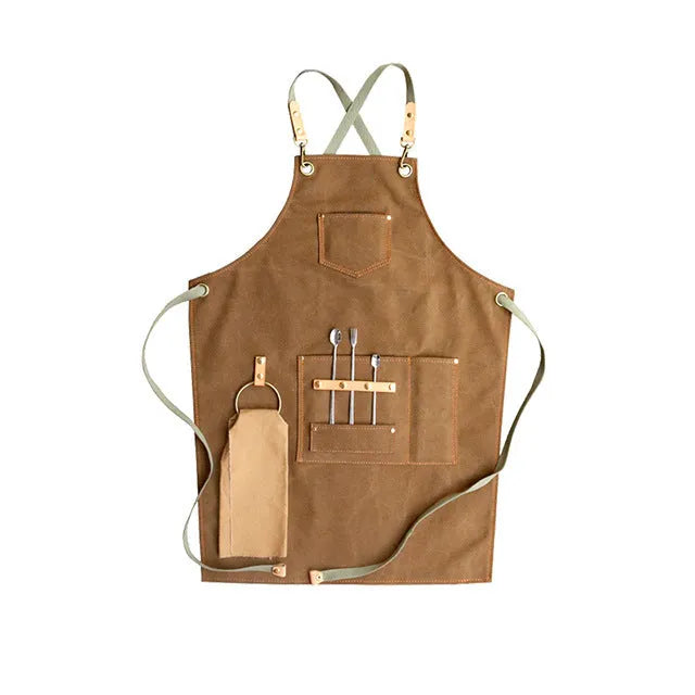 Canvas cross-strap apron in camel colour on hanger