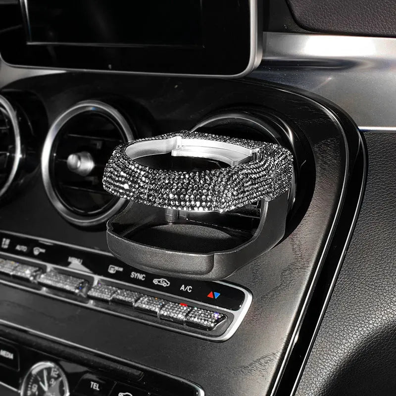Car interior water cup bracket with decorative diamond accents mounted on air vent