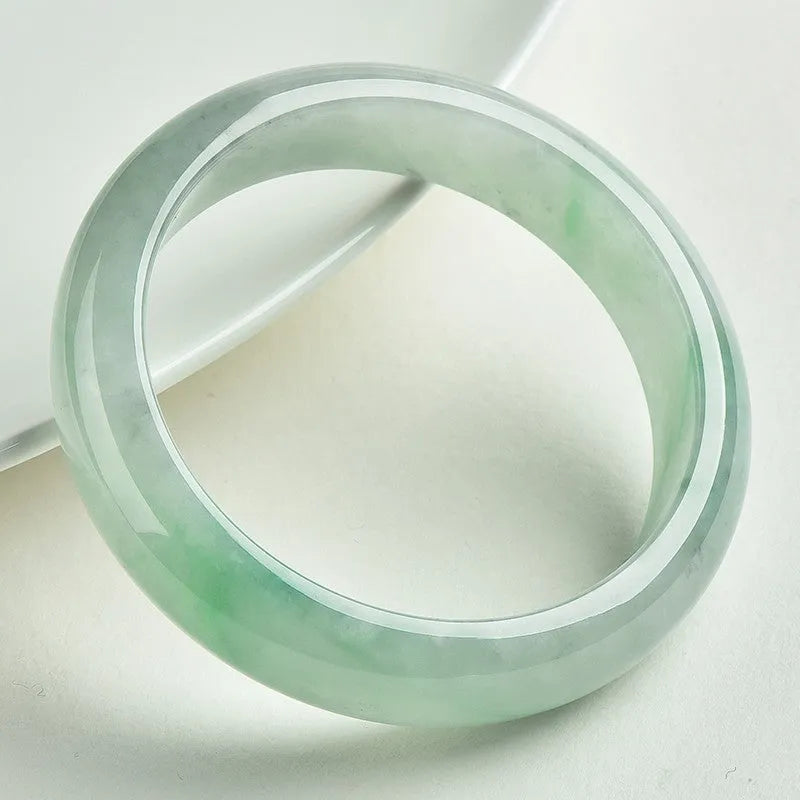 Light green jade bracelet showing natural stone texture on wrist