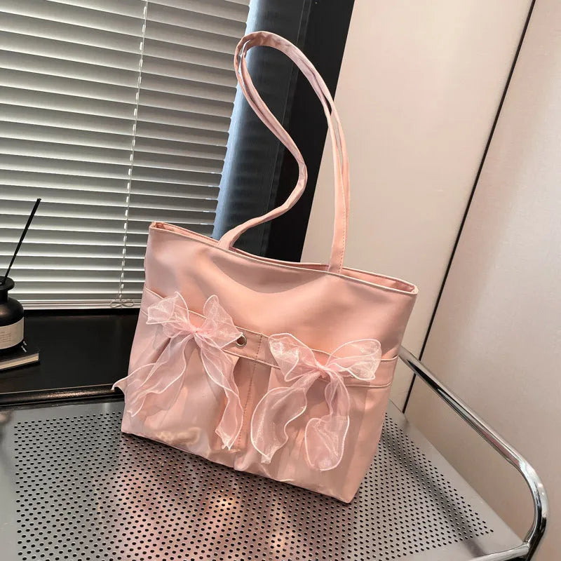 College style bow tote bag in black with double shoulder straps and decorative bow