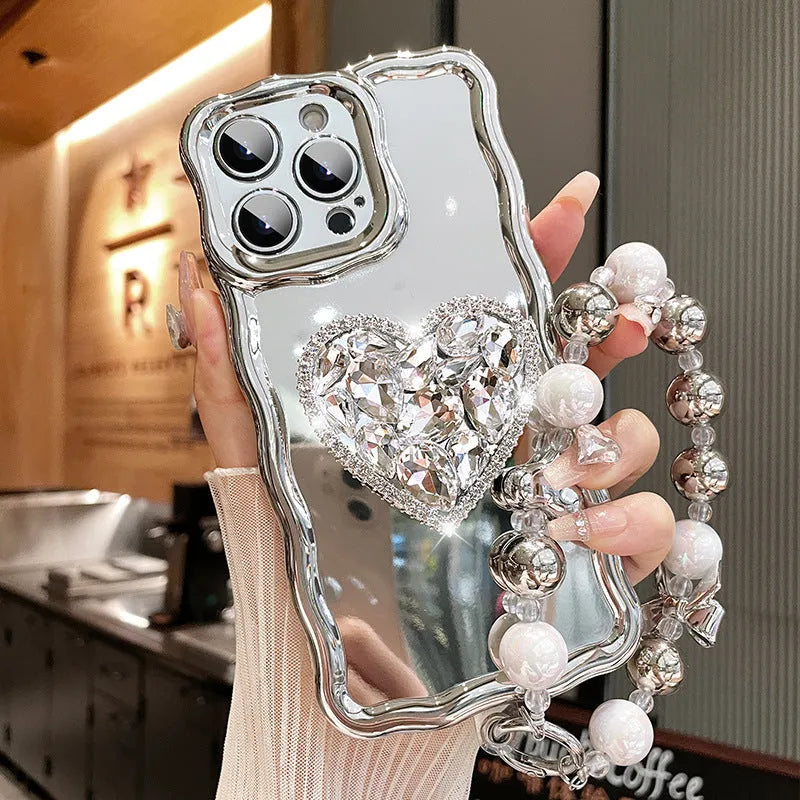 Silver grey silicone iPhone case with mirror finish, rhinestone bracket, and wrist strap lanyard