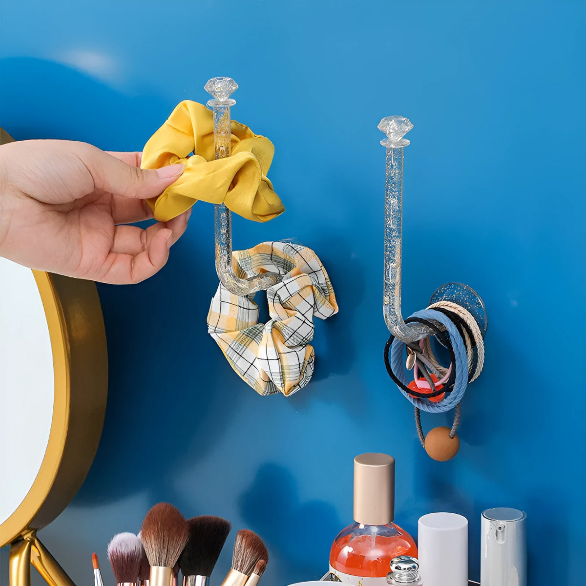 White plastic diamond crystal storage hook mounted on wall holding keys and small accessories