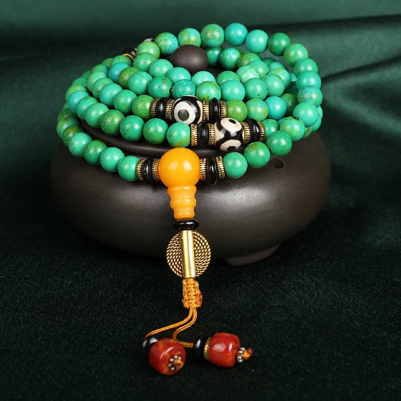 Natural turquoise beaded bracelet with 108 polished 8mm round beads on a wrist.