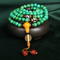 Natural turquoise beaded bracelet with 108 polished 8mm round beads on a wrist.