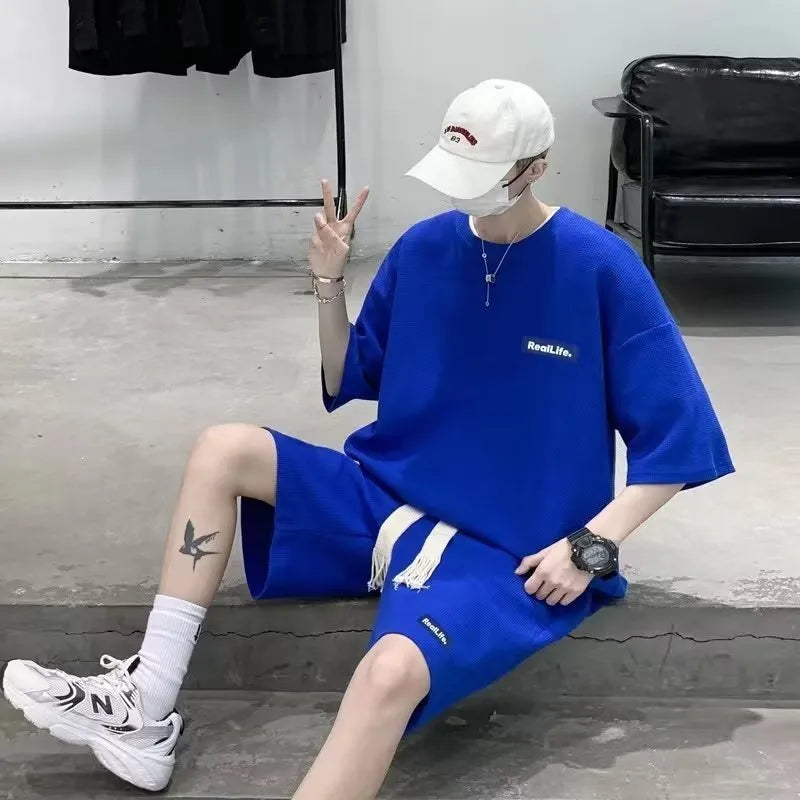 Waffle textured cotton polyester leisure sports suit set in blue, showing short sleeve top and shorts