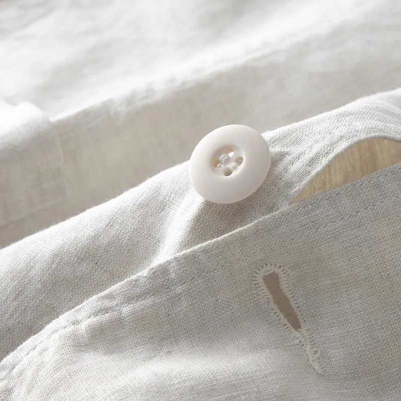 Men's casual linen suit jacket in a solid colour on a hanger, showing long sleeves and a relaxed fit.