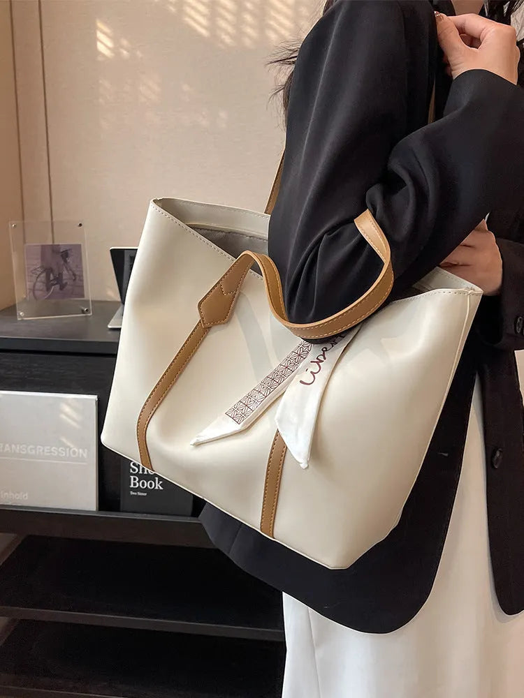 Women's soft bucket tote bag in multiple colours with crossbody strap and zippered internal compartment