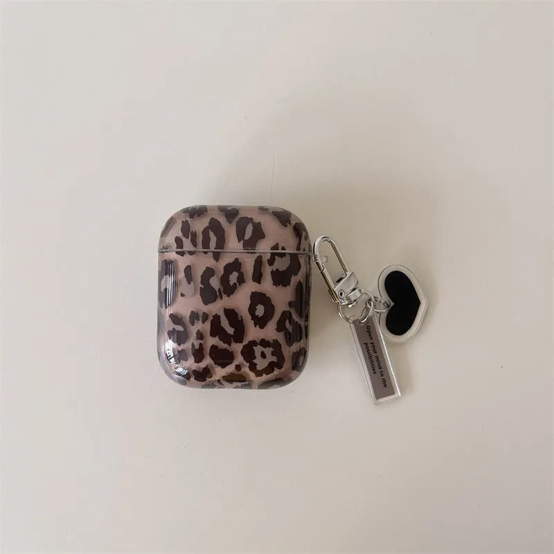 Transparent brown leopard printed PC earphone sleeve on Apple AirPods charging case showing visible logo and spotted pattern