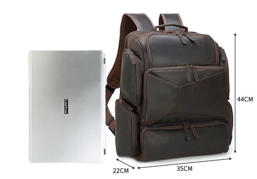 Dark brown retro genuine leather backpack for men, open to show laptop compartment and internal organisers.