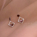 925 sterling silver asymmetrical stud earrings with frosty brown finish heart-shaped love motif on white background
