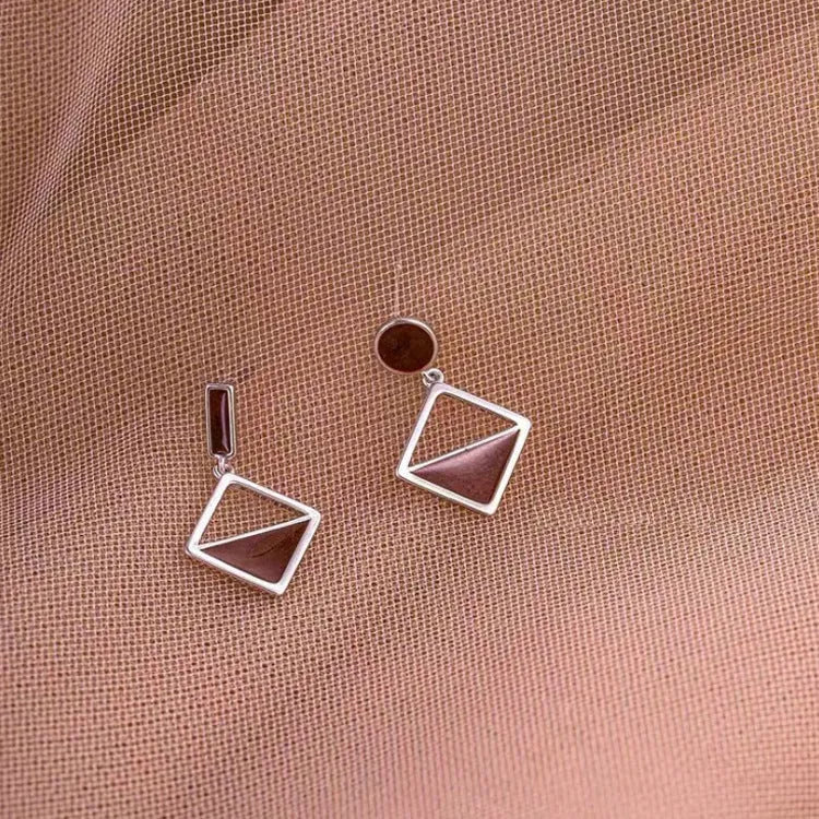 925 sterling silver asymmetrical stud earrings with frosty brown finish heart-shaped love motif on white background