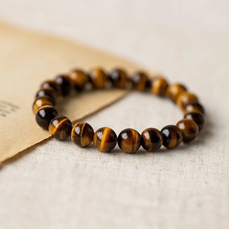 Ethnic style single circle bracelet with a patterned Tigereye Dzi bead on wrist.