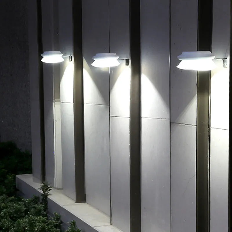 Solar-powered outdoor garden wall lamp with Southeast Asian design on fence
