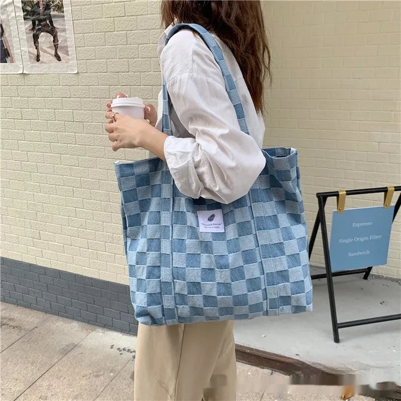 Women's large canvas shoulder bag in Oxford cloth with a three-dimensional front pocket, shown in various colours.