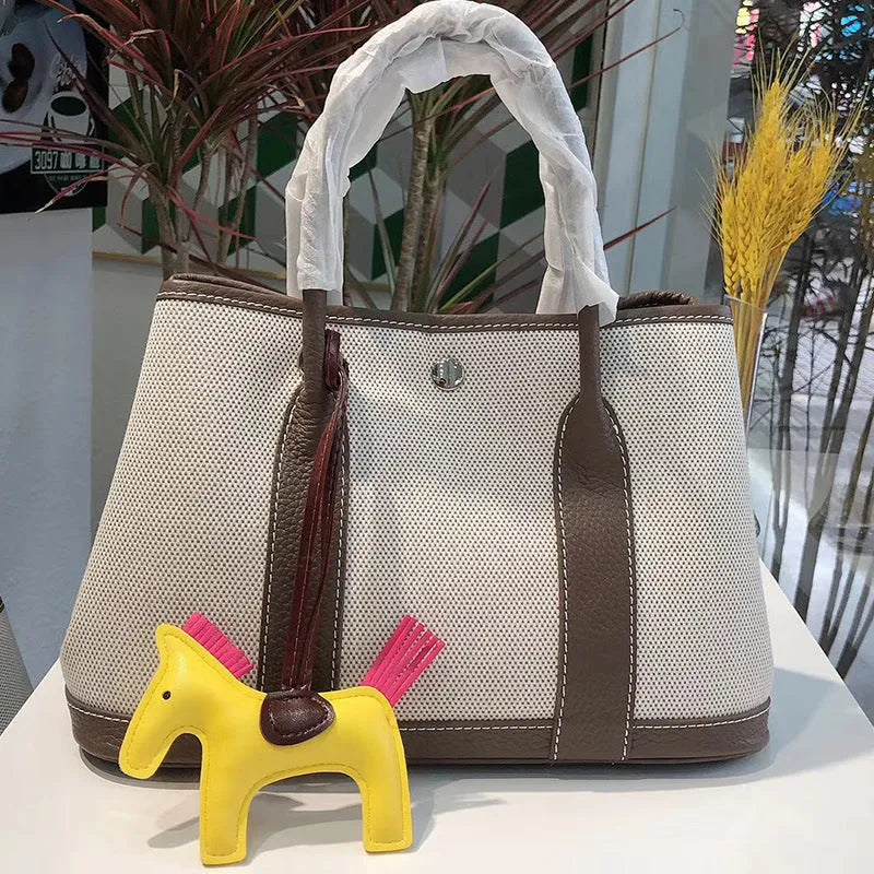 Women's genuine leather crossbody bucket bag showing internal organisation compartments