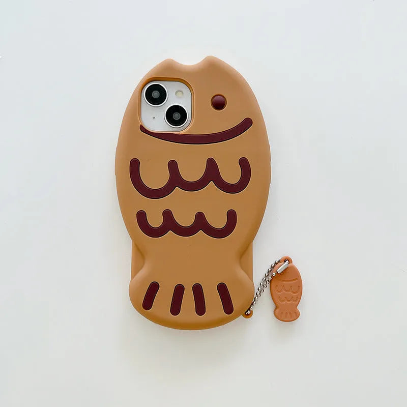 Brown silicone phone case with 3D taiyaki design and hanging ornament for iPhone.