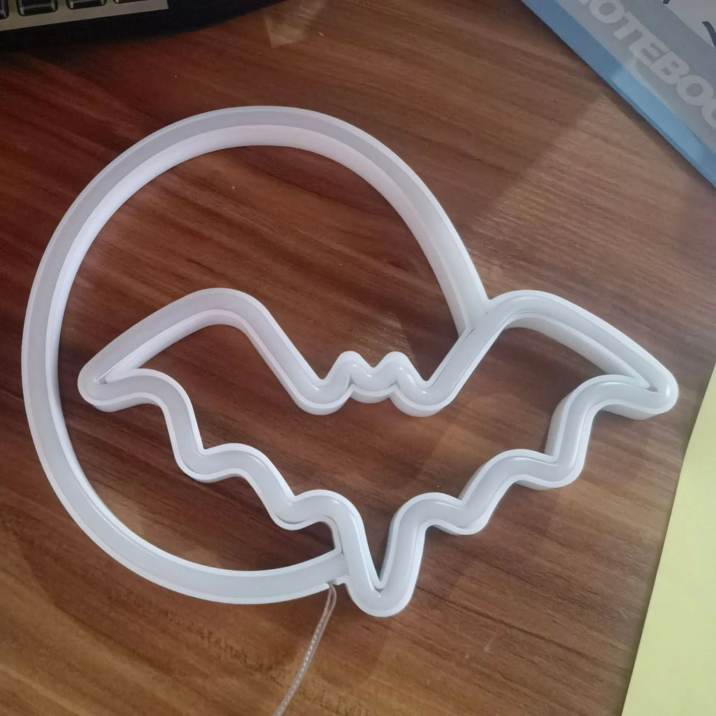 Halloween bat shaped neon light with plastic shell in pink and blue colour options on a dark background