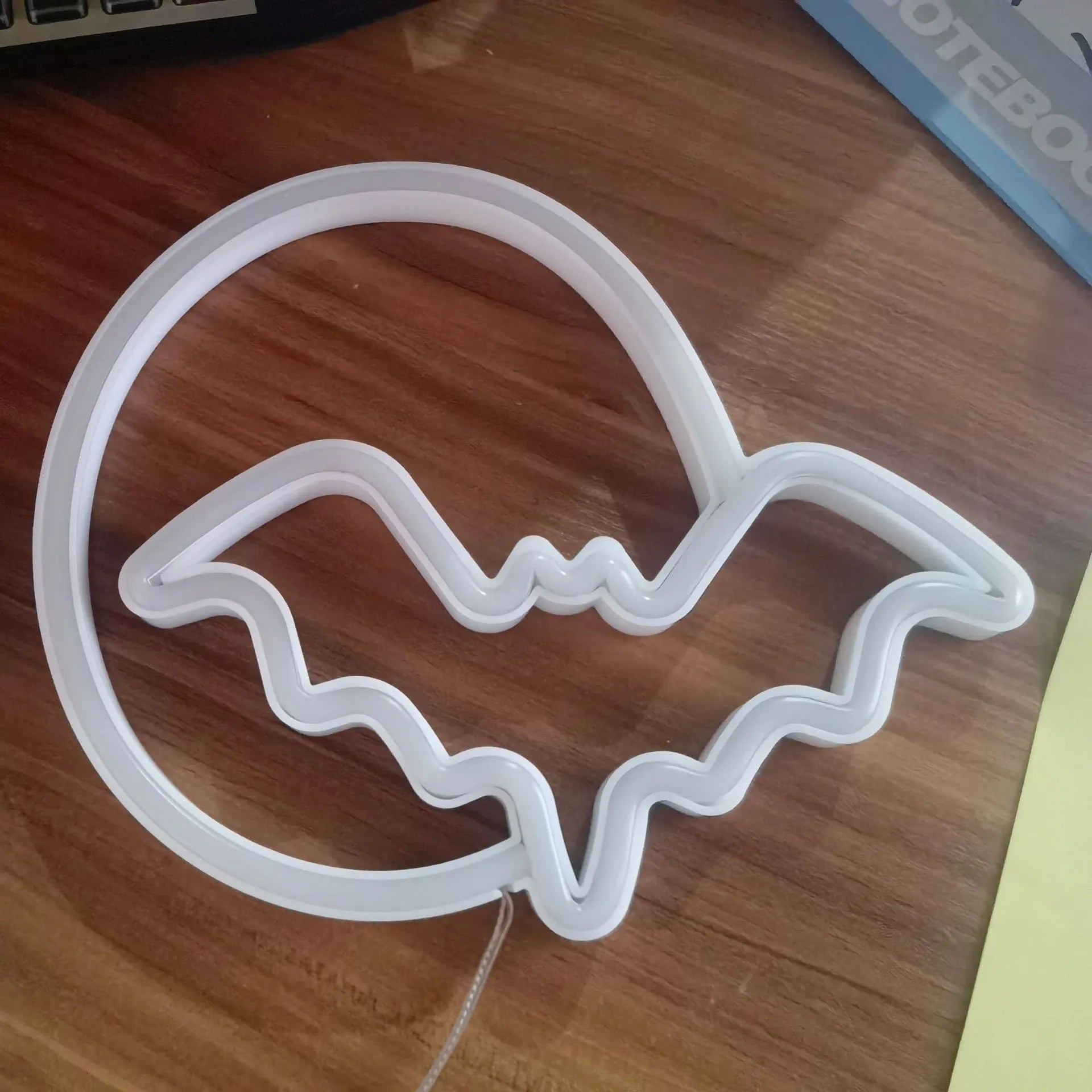 Halloween bat shaped neon light with plastic shell in pink and blue colour options on a dark background
