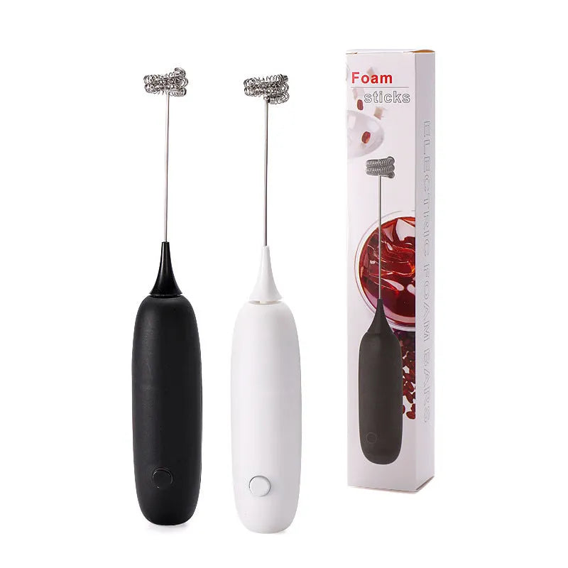 Electric hand-held milk frother in black and white colours for coffee preparation